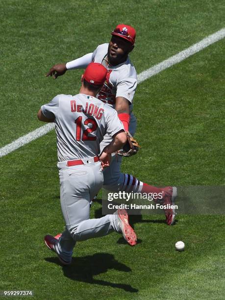 The ball hit by Eddie Rosario of the Minnesota Twins drops between Paul DeJong and Marcell Ozuna of the St. Louis Cardinals during the fifth inning...