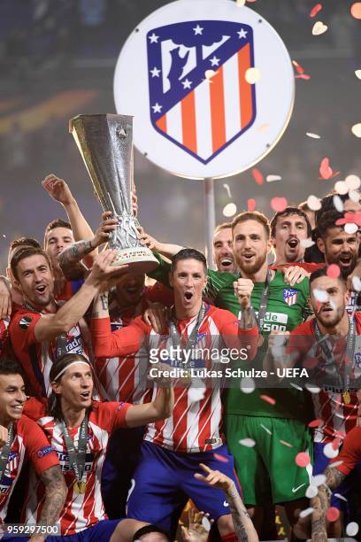 Gabi and Fernando Torres of Atletico Madrid lift the Europa League trophy following victory after the UEFA Europa League Final between Olympique de...