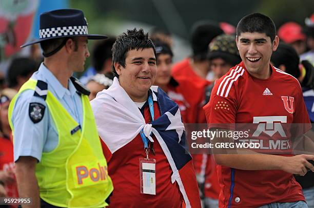 An Australian policeman keeps an eye on Chilean supporters following the men's singles three round match between Fernando Gonzalex of Chile and...