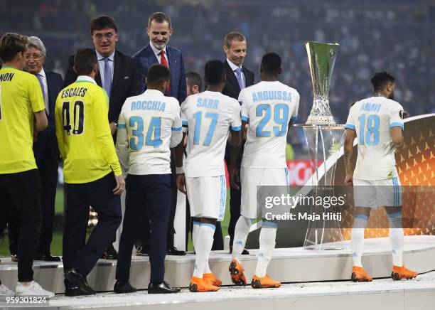 President Aleksander Ceferin and King Felipe of Spain greet dejected Marseille players after the UEFA Europa League Final between Olympique de...