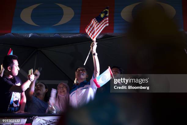 Malaysian politician Anwar Ibrahim, center, waves a Malaysian flag during a Pakatan Harapan alliance event in Petaling Jaya, Selangor, Malaysia, on...