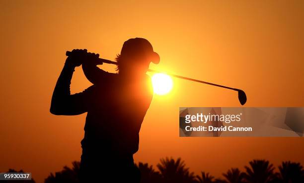 Camilo Villegas of Colombia warms up on the driving range against the rising desert sun before he started his second round of The Abu Dhabi Golf...