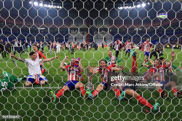 Atletico Madrid players celebrate in the goal mouth with the trophy during the UEFA Europa League Final between Olympique de Marseille and Club...