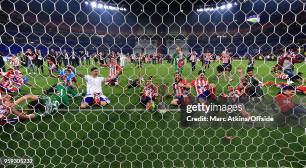 Atletico Madrid players celebrate in the goal mouth with the trophy during the UEFA Europa League Final between Olympique de Marseille and Club...