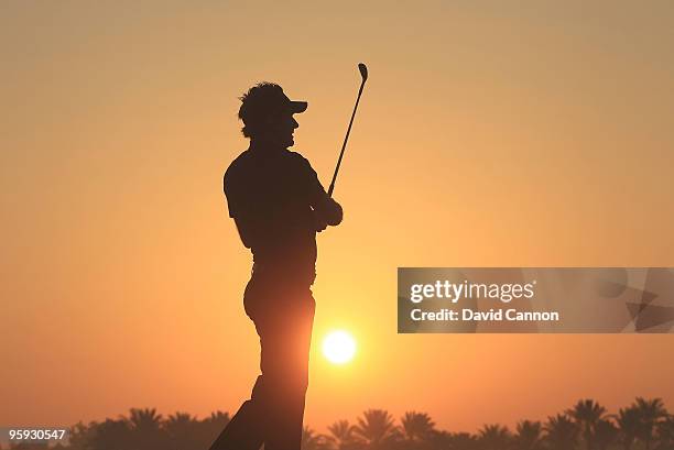 Ian Poulter of England warms up on the practice ground against the rising desert sun before he teed off during the second round of The Abu Dhabi Golf...