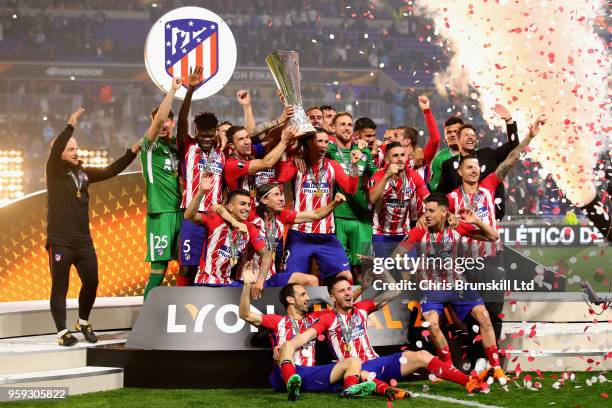 Gabi of Club Atletico de Madrid and his team lift the trophy after winning during the UEFA Europa League Final between Olympique de Marseille and...