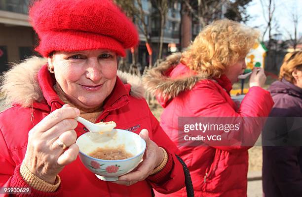 Foreign residents enjoy Laba porridge on January 22, 2010 in Lianyungang, Jiangsu province of China. The traditional Laba Festival falls on the 8th...