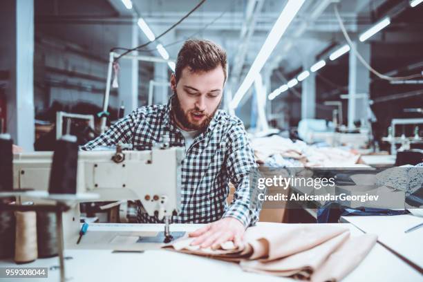 male adult worker sewing in textile factory - leather industry stock pictures, royalty-free photos & images