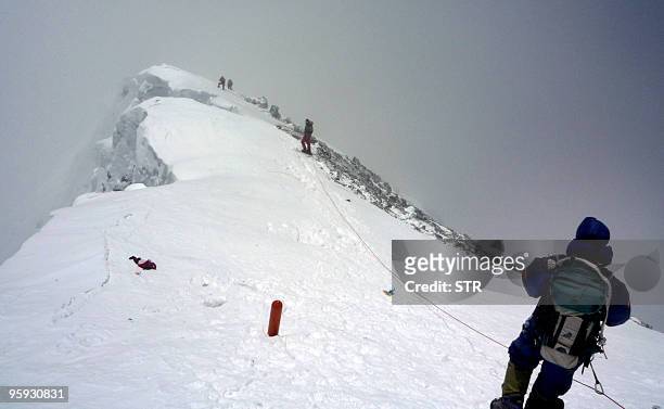 Nepal-Everest-environment-climbing, FOCUS by Deepesh Shrestha In this May 19, 2009 file photograph, unidentified mountaineers descend Mount Everest....