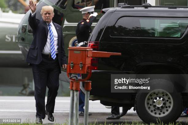 President Donald Trump waves after exiting Marine One to visit First Lady Melania Trump at Walter Reed National Military Medical Center in Bethesda,...
