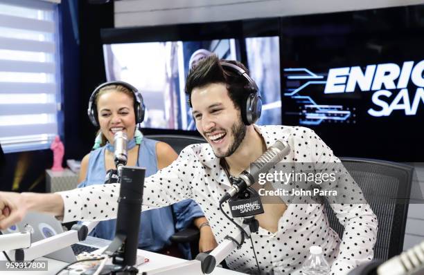 Gina Ulmos and Sebastian Yatra are seen at "The Enrique Santos Show" at I Heart Latino Studios on May 16, 2018 in Miramar, Florida.