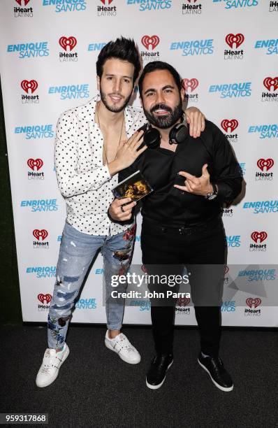 Enrique Santos and Sebastian Yatra are seen at "The Enrique Santos Show" at I Heart Latino Studios on May 16, 2018 in Miramar, Florida.