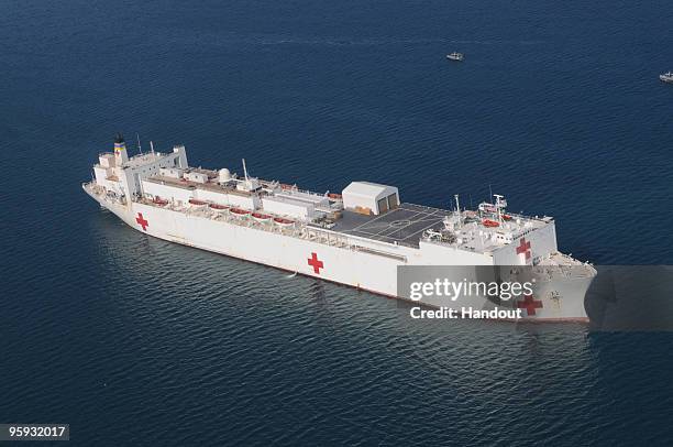 In this handout image provided by U.S. Navy, The Military Sealift Command hospital ship USNS Comfort is anchored off the coast of Haiti to support...