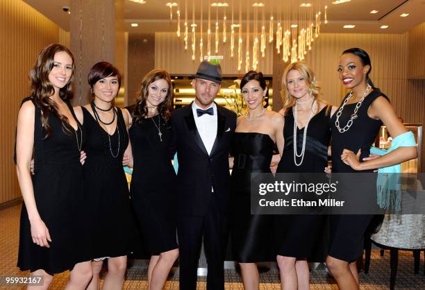 Singer/songwriter Matt Goss poses with models after performing during a grand opening cocktail party at the Tiffany & Co. Store at Crystals at...