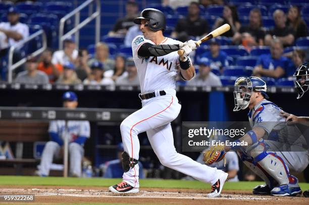 Martin Prado of the Miami Marlins singles in the first inning of the game against the Los Angeles Dodgers at Marlins Park on May 16, 2018 in Miami,...