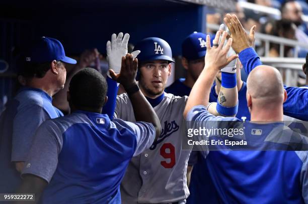 Yasmani Grandal of the Los Angeles Dodgers is congratulated teammates after hitting a home run in the fourth inning against the Miami Marlins at...
