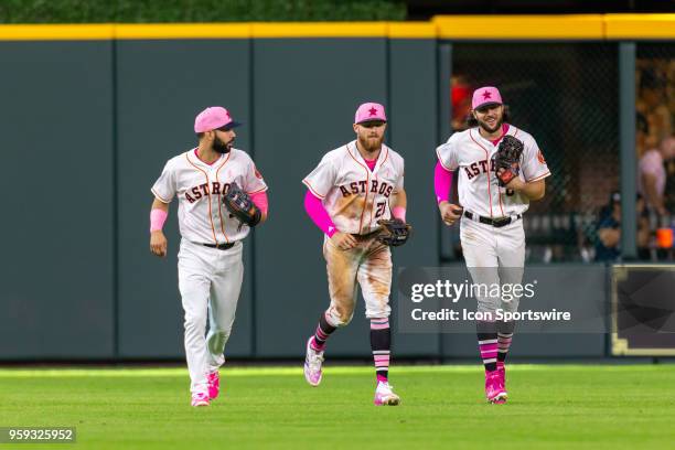 Houston Astros left fielder Marwin Gonzalez , Houston Astros right fielder Derek Fisher and Houston Astros center fielder Jake Marisnick jogging to...