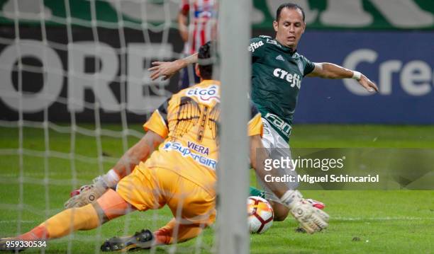 Guerra of Palmeiras of Brazil vies for the ball with goalkeeper Sebastian Viera of Junior Barranquilla of Colombia during the match for the Copa...
