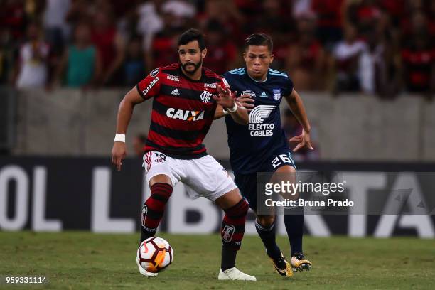 Henrique Dourado of Flamengo struggles for the ball with a MejiÌa of Emelec during a Group Stage match between Flamengo and Emelec as part of Copa...