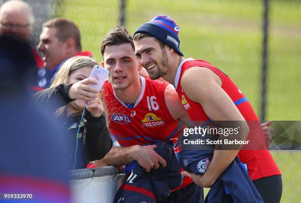 Toby McLean of the Bulldogs and Easton Wood of the Bulldogs pose for a photo with a supporter during a Western Bulldogs AFL training session at...