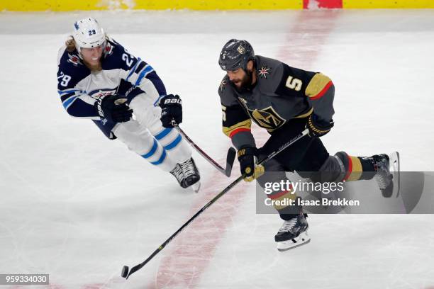 Deryk Engelland of the Vegas Golden Knights is defended by Patrik Laine of the Winnipeg Jets during the first period in Game Three of the Western...