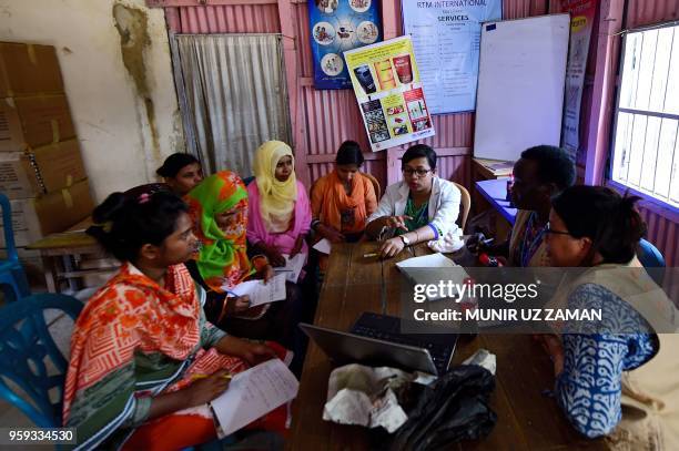 This photograph taken on April May 8, 2018 shows midwives attending a meeting on gender-based violence with United Nations Population Fund workers at...