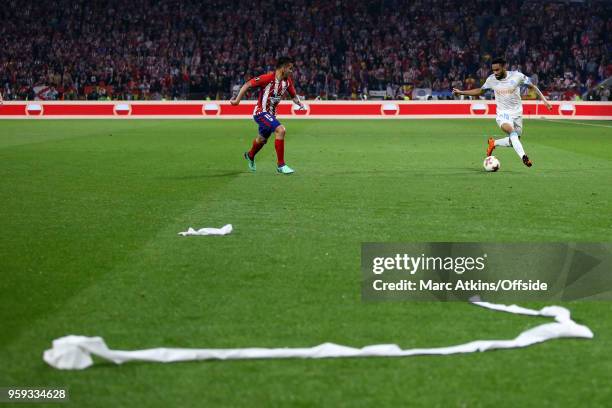 Toilet roll strewn onto the pitch as Jordan Amavi of Olympique de Marseille takes on Angel Correa of Atletico Madrid during the UEFA Europa League...