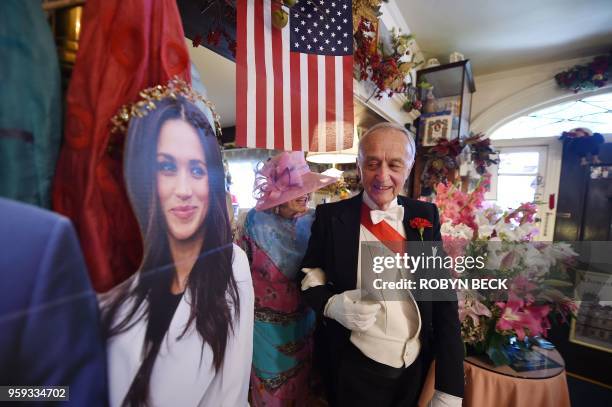 Edmund Fry leads guests past a cardboard cutout of Meghan Markle to their table for traditional English afternoon tea at The Rose Tree Cottage in...