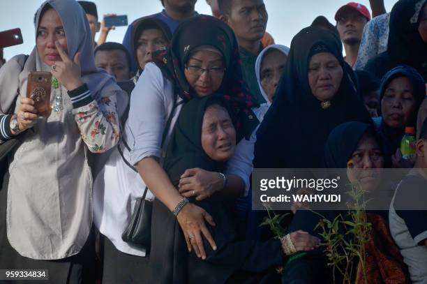 This picture taken in Pekanbaru, Riau on May 16, 2018 shows daughter of Auzar , who was killed during an attack at a police headquarters, during his...