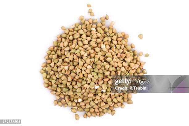 pile of organic bio buckwheat raw on white background - buckwheat isolated stock pictures, royalty-free photos & images