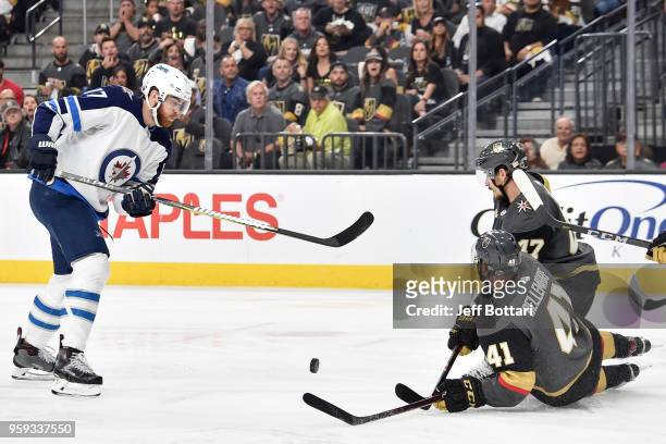 Luca Sbisa and Pierre-Edouard Bellemare of the Vegas Golden Knights defend against Adam Lowry of the Winnipeg Jets in Game Three of the Western...