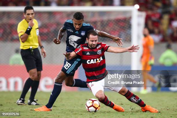 Everton Ribeiro of Flamengo struggles for the ball with a Ayrton Preciado of Emelec during a Group Stage match between Flamengo and Emelec as part of...