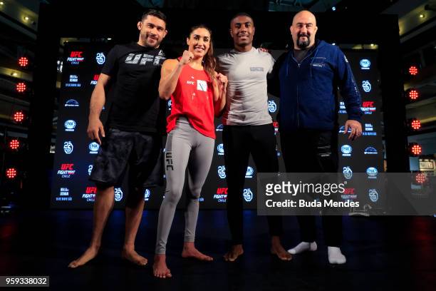 Women's strawweight contender Tatiana Suarez of the United States with her teammates pose for photographers during an open training session at Mall...