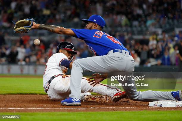 Ronald Acuna Jr. #13 of the Atlanta Braves slides safely into third base against Carl Edwards Jr. #6 of the Chicago Cubs on a single hit by Freddie...