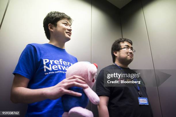 Toru Nishikawa, co-founder and chief executive officer of Preferred Networks Inc., right, and Daisuke Okanohara, co-founder and vice president, ride...