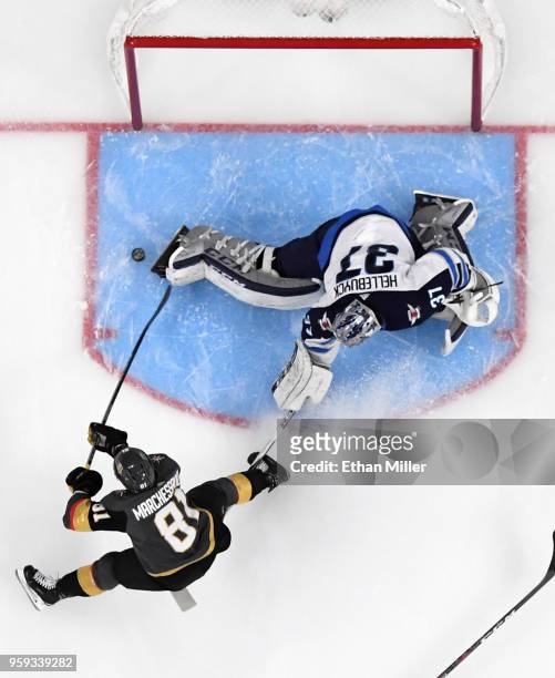 Jonathan Marchessault of the Vegas Golden Knights scores a first-period goal against Connor Hellebuyck of the Winnipeg Jets in Game Three of the...