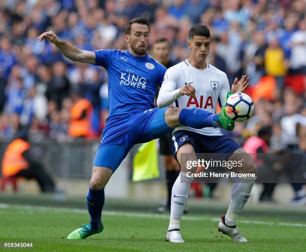 Christian Fuchs of Leicester City kicks the ball against Erik Lamela of Tottenham Hotspur during the Premier League match between Tottenham Hotspur...