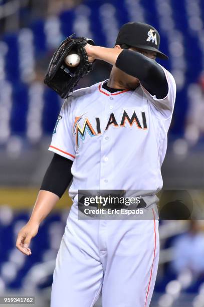 Junichi Tazawa of the Miami Marlins wipes his forehead during the sixth inning against the Los Angeles Dodgers at Marlins Park on May 16, 2018 in...