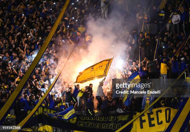 Fans of Boca Juniors light flares to celebrate after winning a match between Boca Juniors and Alianza Lima at Alberto J. Armando Stadium on May 16,...