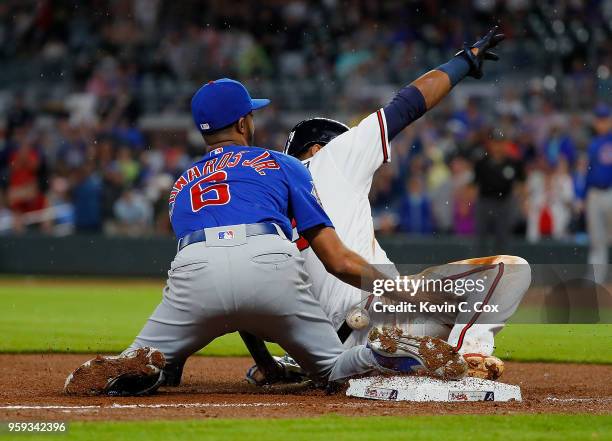 Ronald Acuna Jr. #13 of the Atlanta Braves slides safely into third base against Carl Edwards Jr. #6 of the Chicago Cubs on a single hit by Freddie...