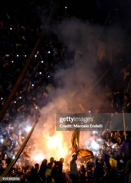 Fans of Boca Juniors light flares to celebrate after winning a match between Boca Juniors and Alianza Lima at Alberto J. Armando Stadium on May 16,...