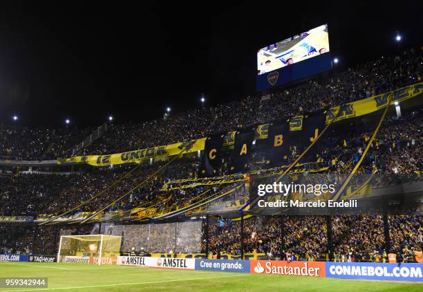 Fans of Boca Juniors cheer their team during a match between Boca Juniors and Alianza Lima at Alberto J. Armando Stadium on May 16, 2018 in La Boca,...