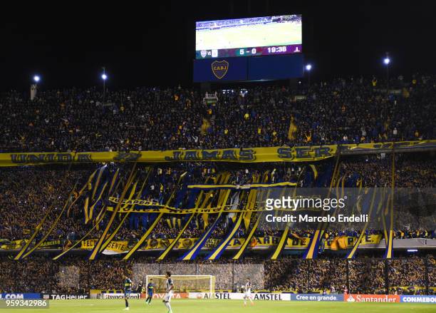 Fans of Boca Juniors cheer their team during a match between Boca Juniors and Alianza Lima at Alberto J. Armando Stadium on May 16, 2018 in La Boca,...