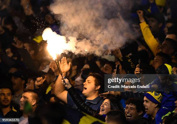 Fans of Boca Juniors light flares to cheer their team during a match between Boca Juniors and Alianza Lima at Alberto J. Armando Stadium on May 16,...