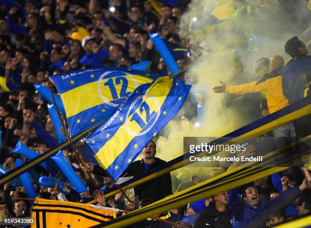 Fans of Boca Juniors wave flags to cheer their team during a match between Boca Juniors and Alianza Lima at Alberto J. Armando Stadium on May 16,...