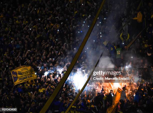 Fans of Boca Juniors light flares to celebrate after winning a match between Boca Juniors and Alianza Lima at Alberto J. Armando Stadium on May 16,...