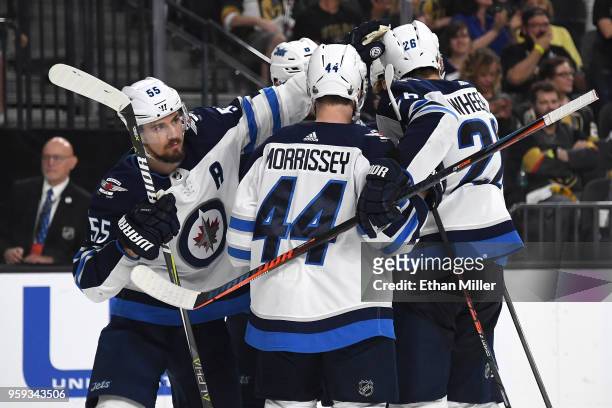 Mark Scheifele of the Winnipeg Jets celebrates with his teammates after scoring a third-period goal against the Vegas Golden Knights in Game Three of...