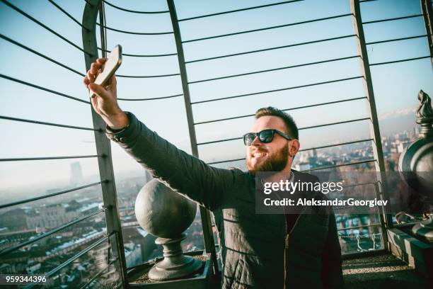 handsome boy with sunglasses taking selfie at beautiful place in turin - turin cathedral stock pictures, royalty-free photos & images