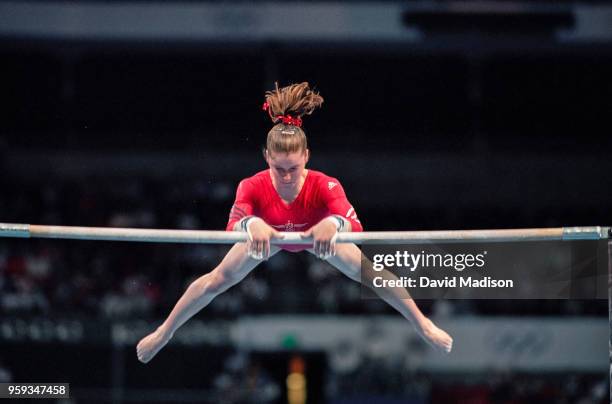 Elise Ray of the United States competes on the uneven bars during the Women's Gymnastics event of the Olympic Games on September 15, 2000 in Sydney,...