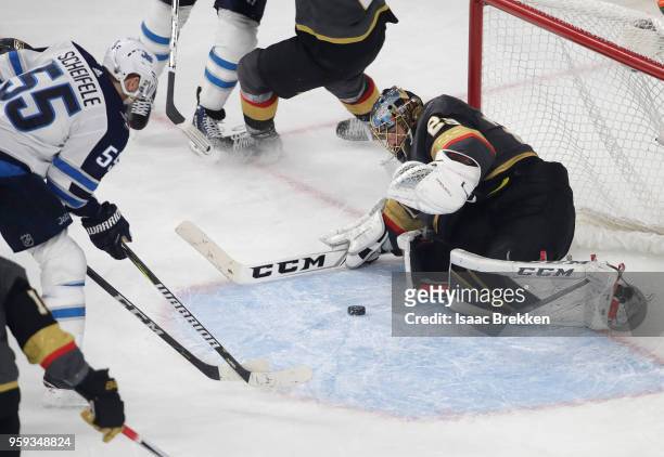 Marc-Andre Fleury of the Vegas Golden Knights stops a shot from Mark Scheifele of the Winnipeg Jets during the third period in Game Three of the...